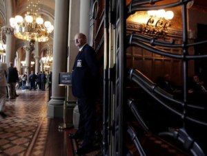 Associated Press A sergeant at arms staff member stands in front of a locked gate leading to the state Senate Chamber at the Capitol in Albany, Wednesday.